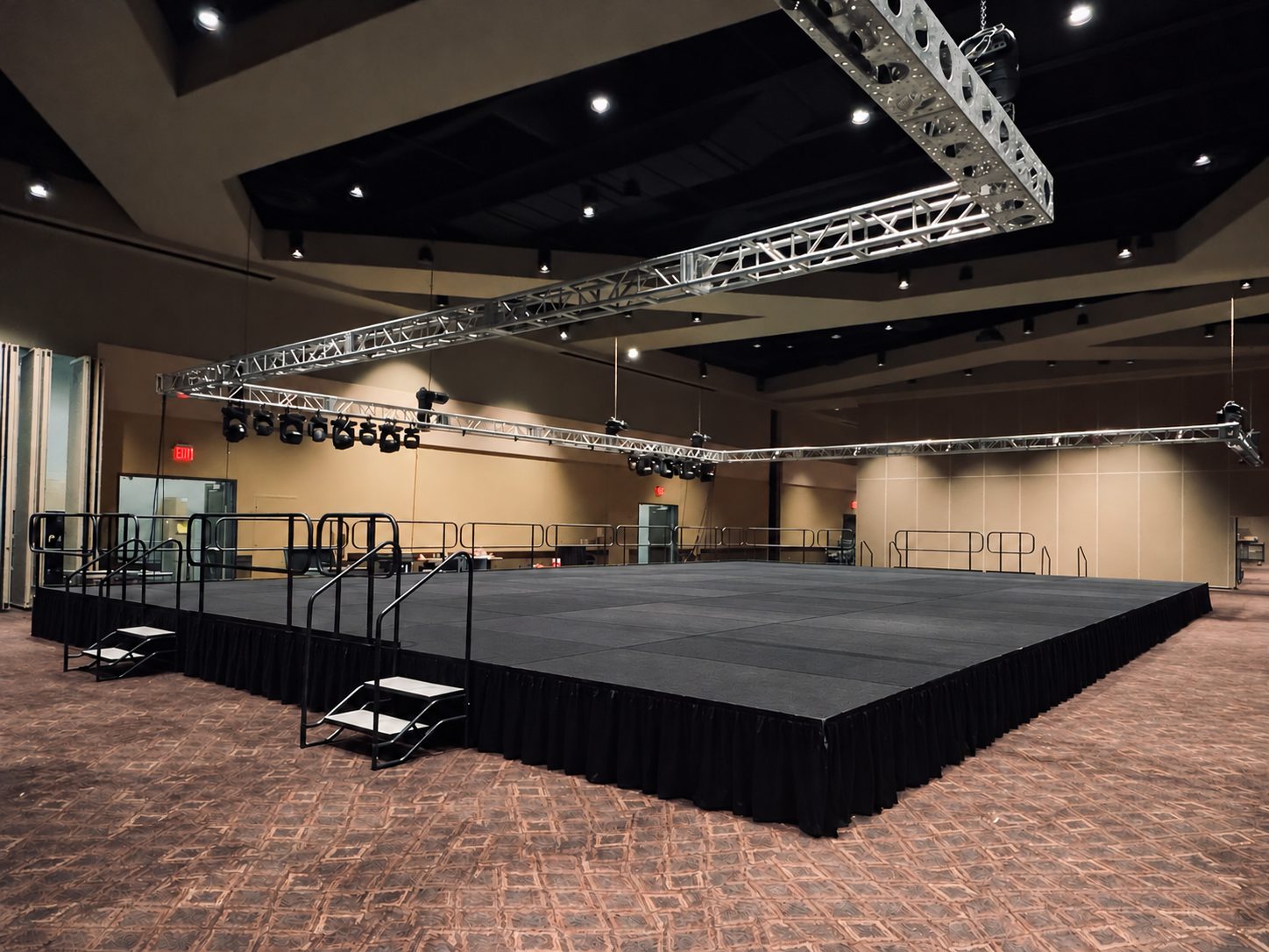 Large modular stage with clear foreground, access stairs and overhead truss