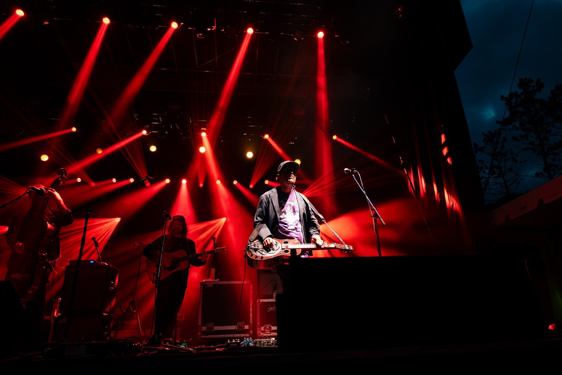 Red lighting beams across a live performance